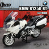 A white BMW R1250 RT motorcycle model in 1:18 scale, shown against a red background.