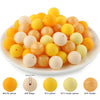 A collection of soft silicone round beads in various shades including yellow, beige, and cream.