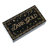 A rectangular box of black and gold foil washi tape set with decorative foliage and stars.