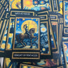 A collection of tarot cards featuring the Knight of Pentacles, with other cards and deck boxes visible.