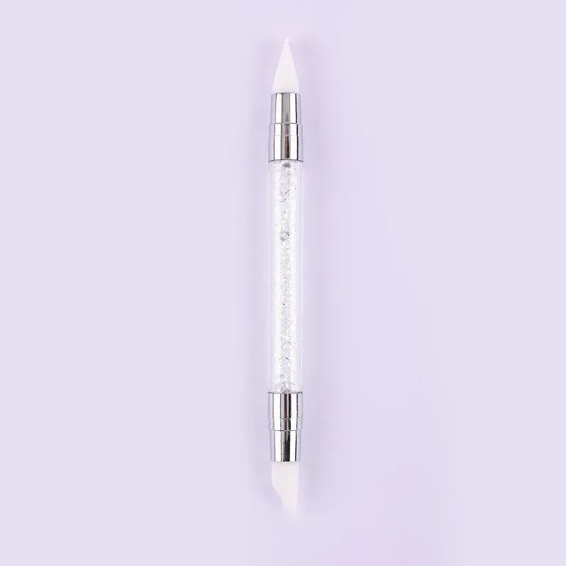 A clear glass dual-ended silicone head nail art dotting pen with a crystal handle.