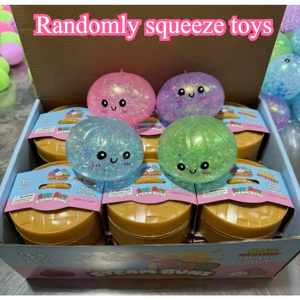 A box of randomly squeezed glitter dumpling stress balls in various colors and sizes.