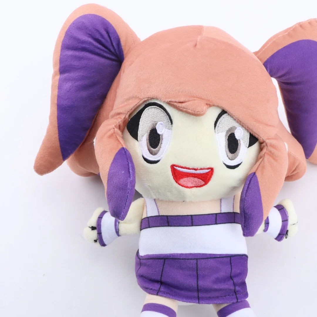 A soft collectible doll plush toy with pink hair and purple ears wearing a white and purple outfit.