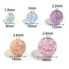 A set of round loose spacer beads made of glitter cracked acrylic in various sizes and shades of purple and pink.