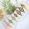 A bundle of metallic glass beads in various geometric patterns and colors for jewelry making