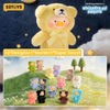 A yellow teddy bear toy is shown with a yellow bow, set against a dark blue background with stars. The image also features va
