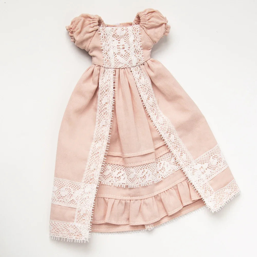A vintage lace maid dress set for a doll featuring a pink bodice and skirt with delicate white lace trim.