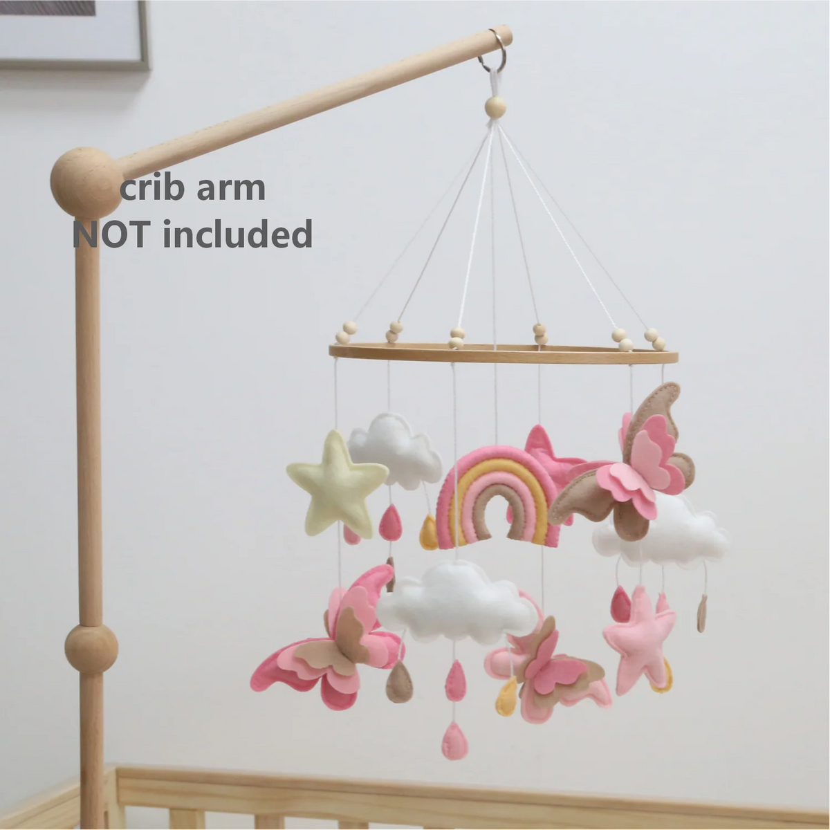 Handmade felt butterfly crib mobile featuring pink, yellow, and white clouds and a rainbow.