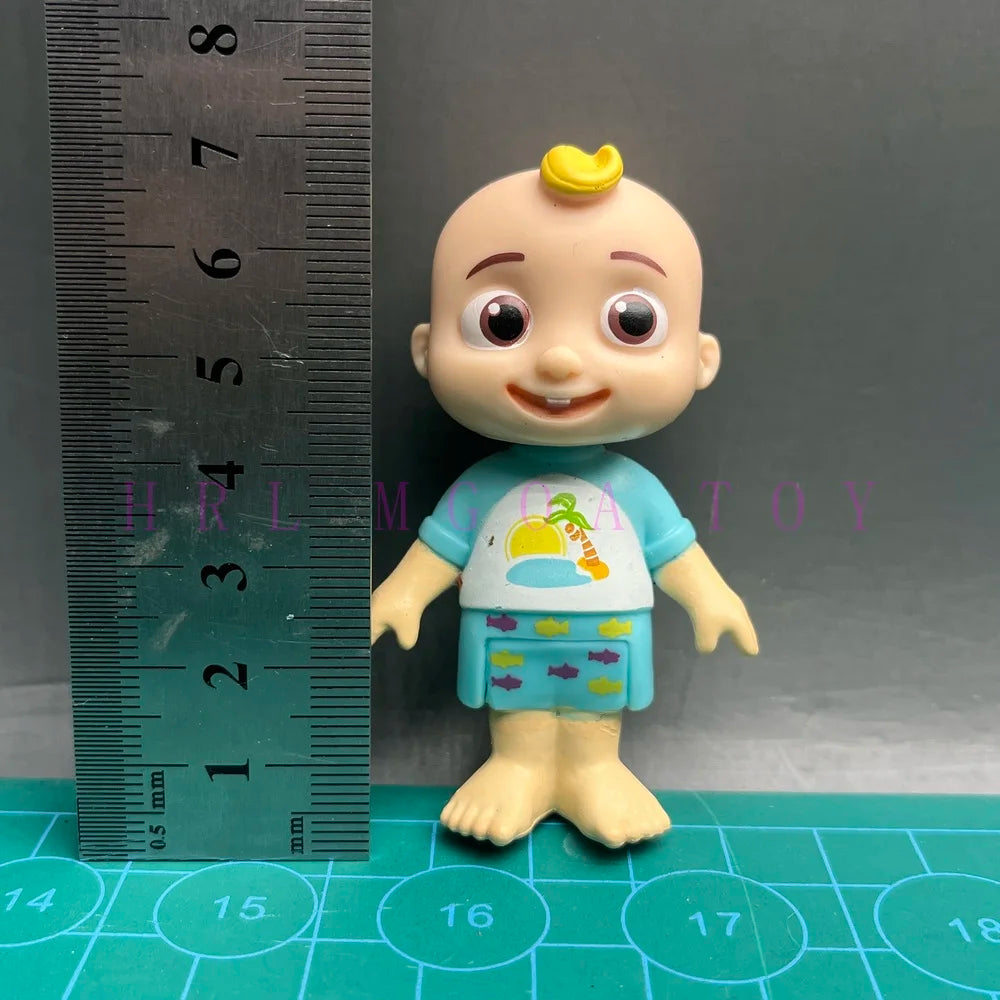 A cute cartoon figurine of a child with yellow hair wearing a blue shirt and shorts, set against a ruler.