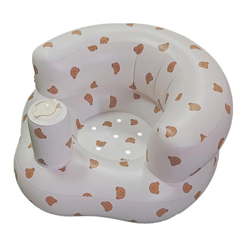 A white inflatable baby sofa with a pattern of light brown baby footprints.