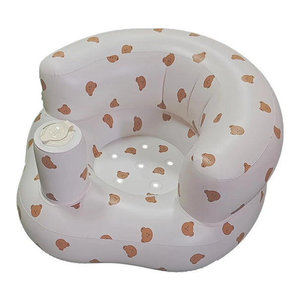 A white inflatable baby sofa with a pattern of light brown baby footprints.