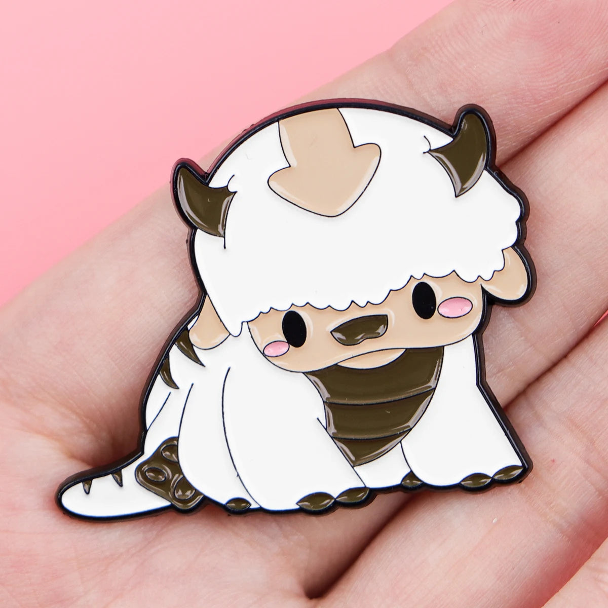 A white cat enamel pin featuring horns and a brown snout, designed for accessories.