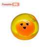 A bright yellow squishy toy shaped like a pumpkin head with a black face and a small yellow opening.