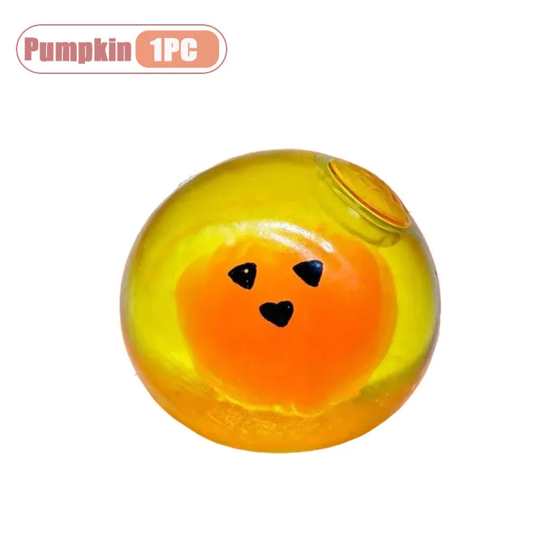 A bright yellow squishy toy shaped like a pumpkin head with a black face and a small yellow opening.