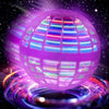 A glowing purple and blue cosmic globe toy surrounded by bright light trails against a dark starry background.
