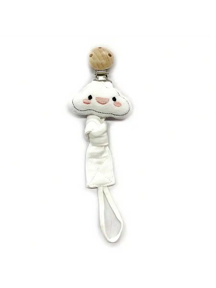A handmade elephant pacifier holder featuring a white fabric design and a wooden top.
