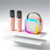 A pink Bluetooth karaoke speaker system with a wireless microphone and a colorful light display.