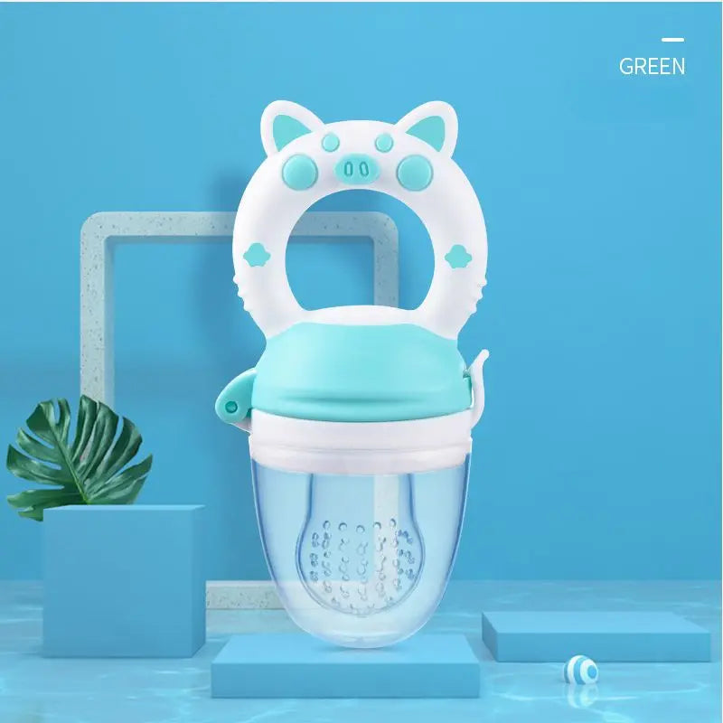 A white silicone baby food feeder with a teal lid and a teether attachment is displayed against a blue background.