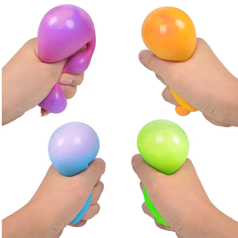 Hands are holding various colored slow-rise stress relief balls including purple, orange, and green.