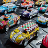 A collection of colorful die-cast mini racing cars displayed on a dark surface.