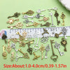 A collection of vintage brass and silver key charms for jewelry making displayed on a ruler.