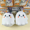 Two white ghost squishy toys with purple accents are shown against a light background.