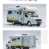 A light blue diecast camping RV model with a white roof and various exterior features.