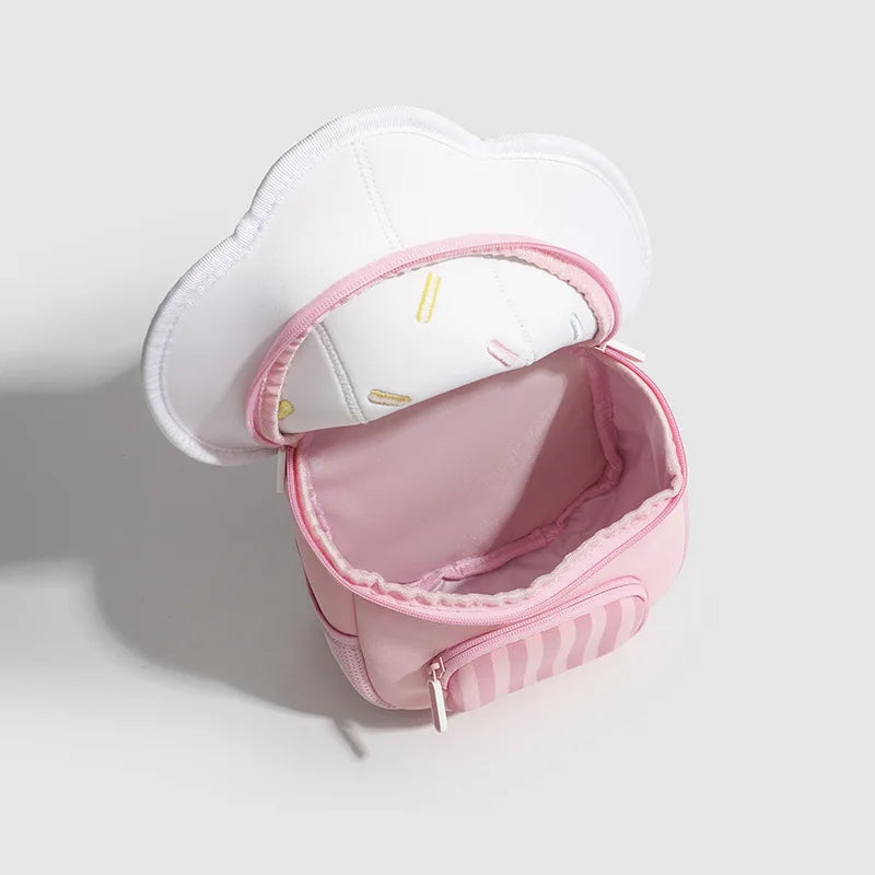 A pink mini backpack with a white mushroom print and a light pink lining is shown open.