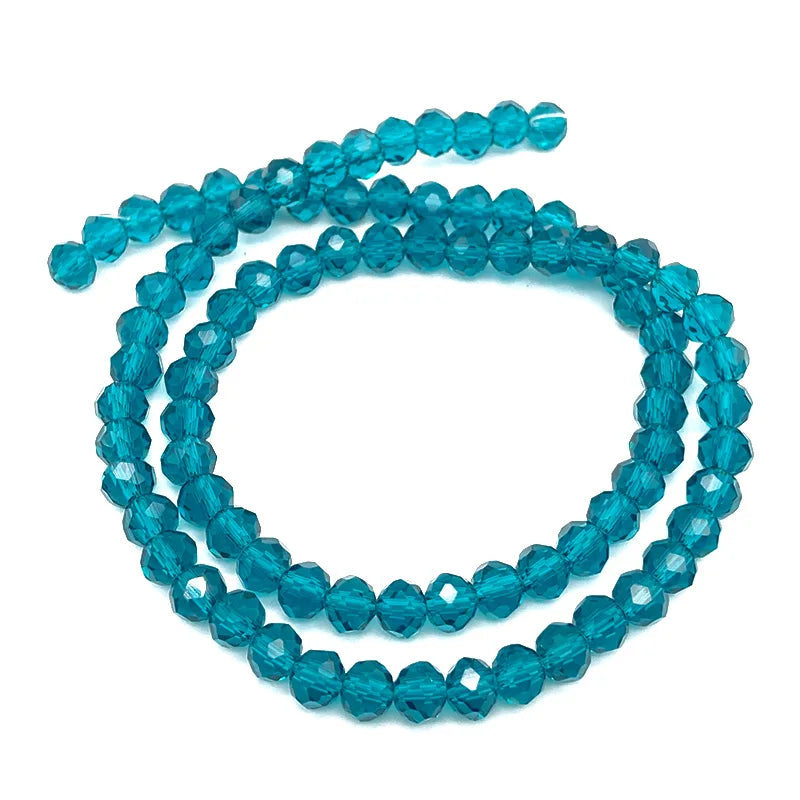 A strand of bright blue faceted crystal beads used for jewelry making.