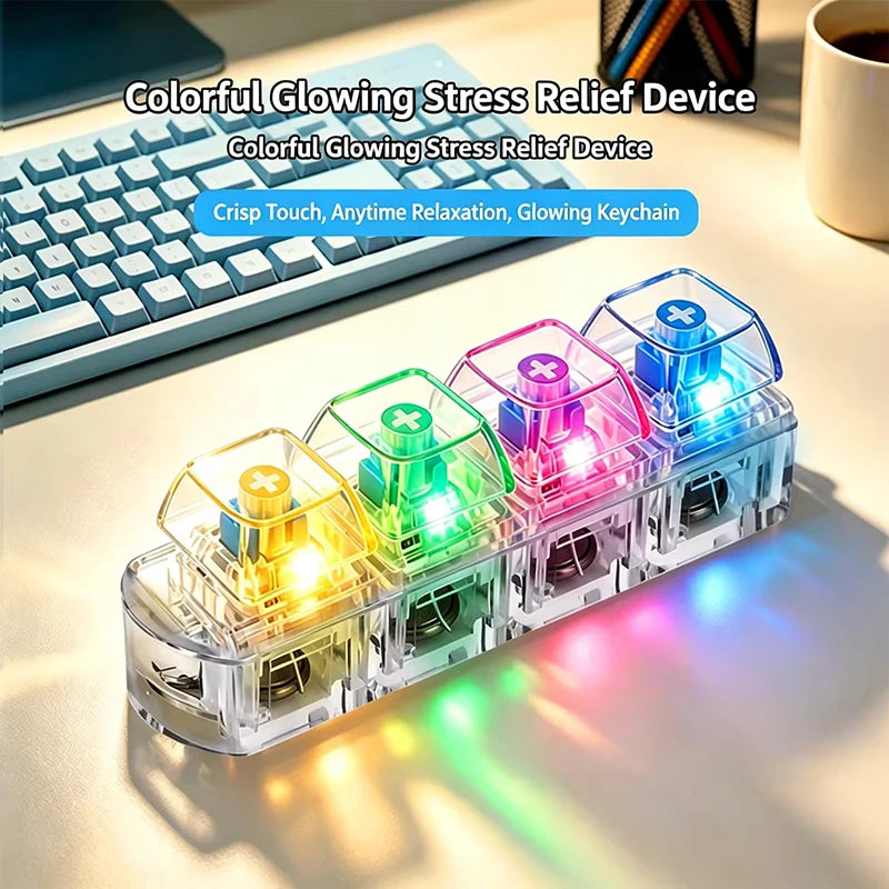 A clear plastic case holds four colorful glowing stress relief devices, featuring LED lights, next to a keyboard.
