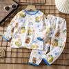 White long sleeve cotton pajama set for kids featuring yellow and orange bear patterns