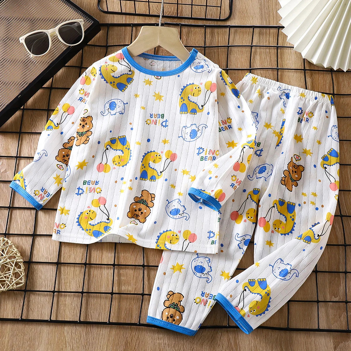 White long sleeve cotton pajama set for kids featuring yellow and orange bear patterns