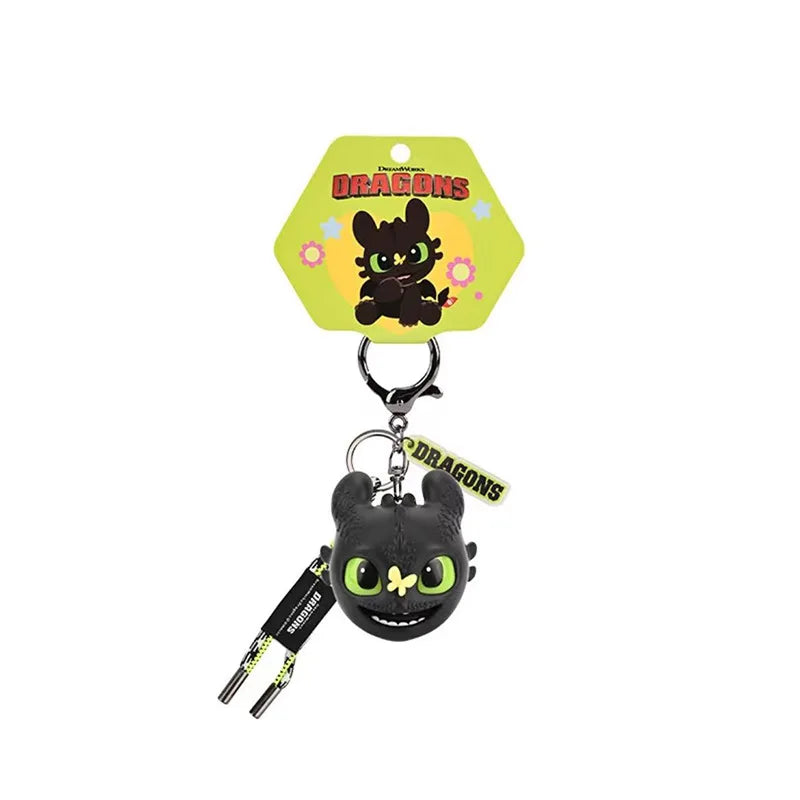 Black Toothless Dragon keychain featuring movable wings and glowing eyes on a yellow tag.