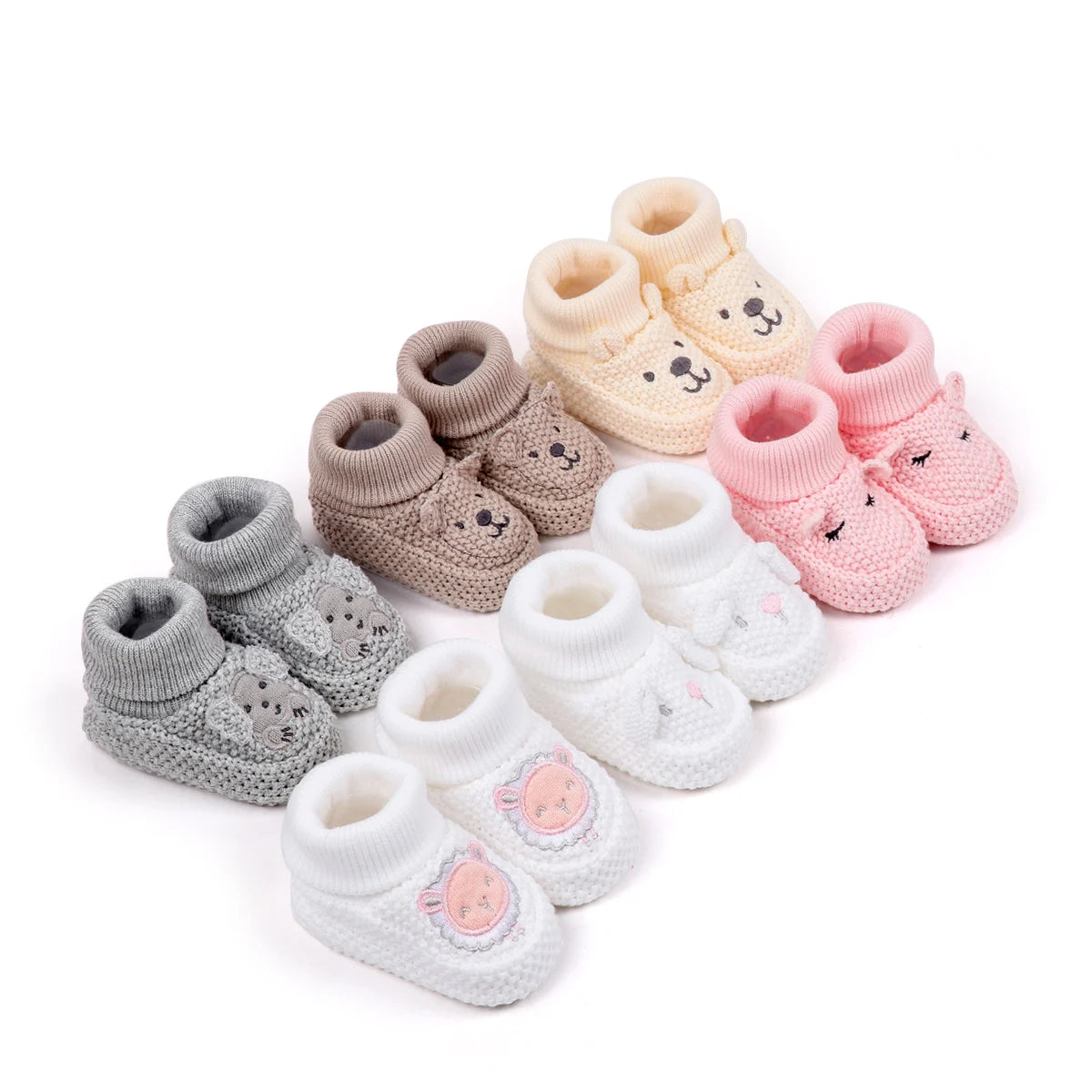A collection of handmade knitted baby booties in various pastel shades including pink, beige, and gray.
