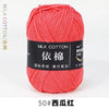 A ball of bright coral red milk cotton yarn labeled 50# West Red.