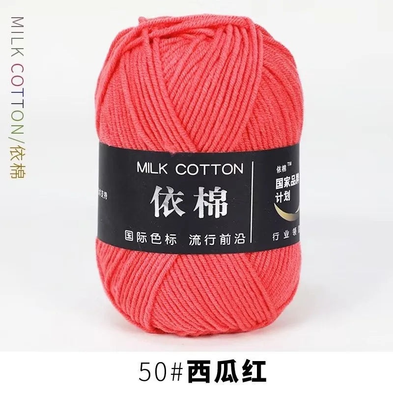 A ball of bright coral red milk cotton yarn labeled 50# West Red.