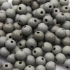 A pile of natural wooden beads in various shades of gray and brown for jewelry making and crafts.