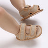 A pair of beige breathable first walker sandals for a baby, shown from the side.