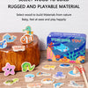 A collection of wooden magnetic fish toys and a blue fishing toy box are displayed on a light wooden surface.