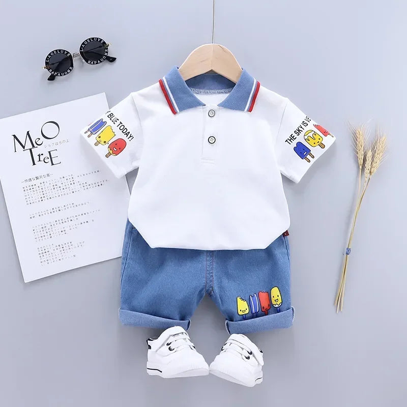 A white short sleeve t-shirt and matching blue denim shorts set for a boy, displayed on a hanger.