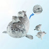 A plush seal family pillow featuring a large adult seal and four baby seals.