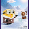 A cute, yellow and brown collectible figure resembling a bear wearing oversized goggles in a snowy landscape.
