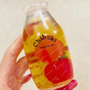 A clear bottle filled with liquid and fruit pieces is held in a hand, labeled Chiboki drink cup toy.