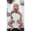 A realistic reborn baby doll kit with painted details and a cloth body is shown from the chest up.