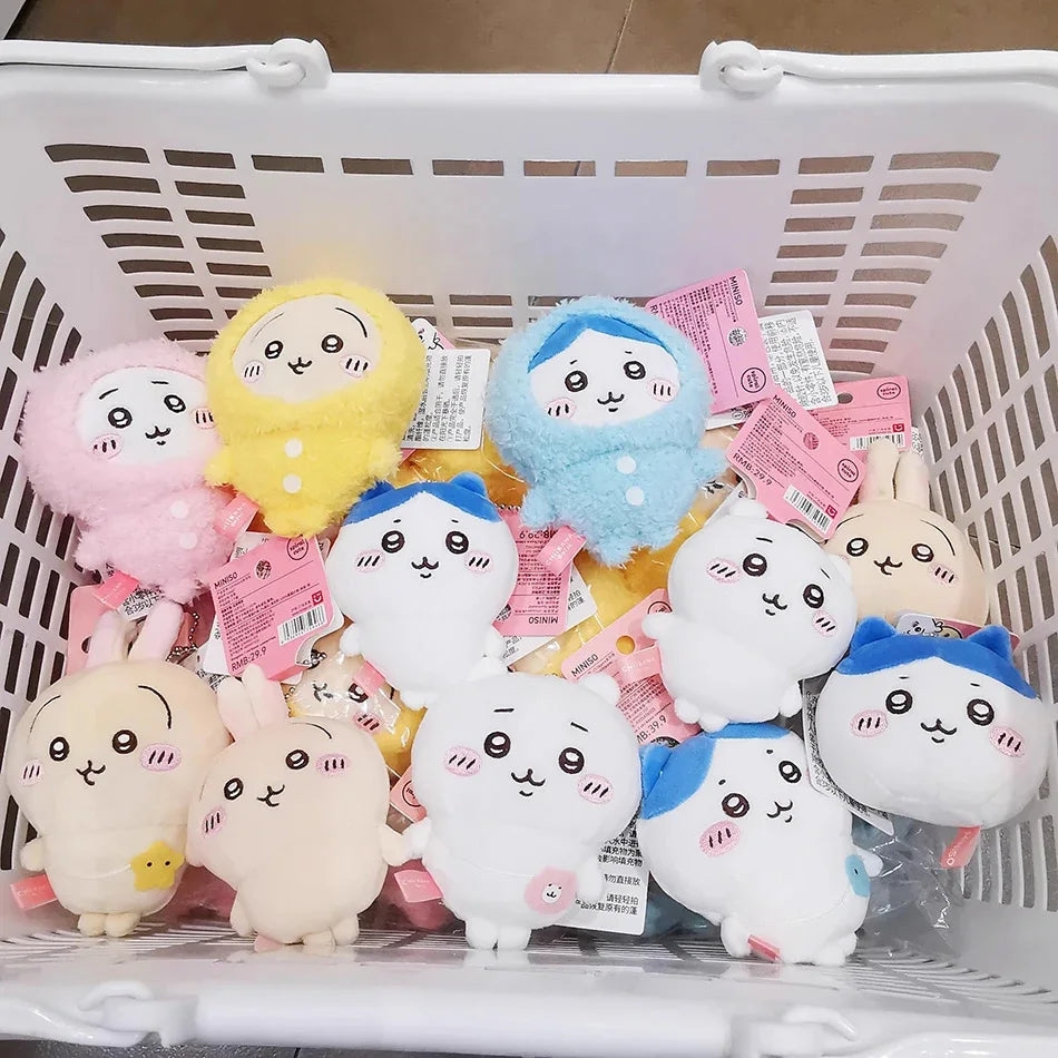 A collection of adorable Usagi Hachiware plush keychains in various pastel colors and designs inside a white basket.