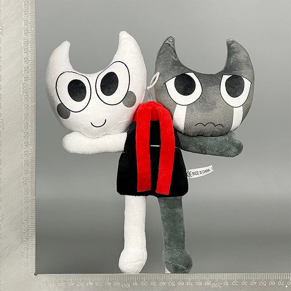 A plush toy resembling a cat face with large eyes and gray fur, displayed against a gray background.