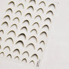 A sheet of gold-colored nail art stickers featuring a pattern of arched shapes.