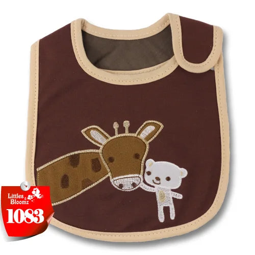 A brown baby feeding bib with a cartoon cow design and beige trim.