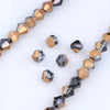 A string of faceted glass beads in gold and gray tones for jewelry making