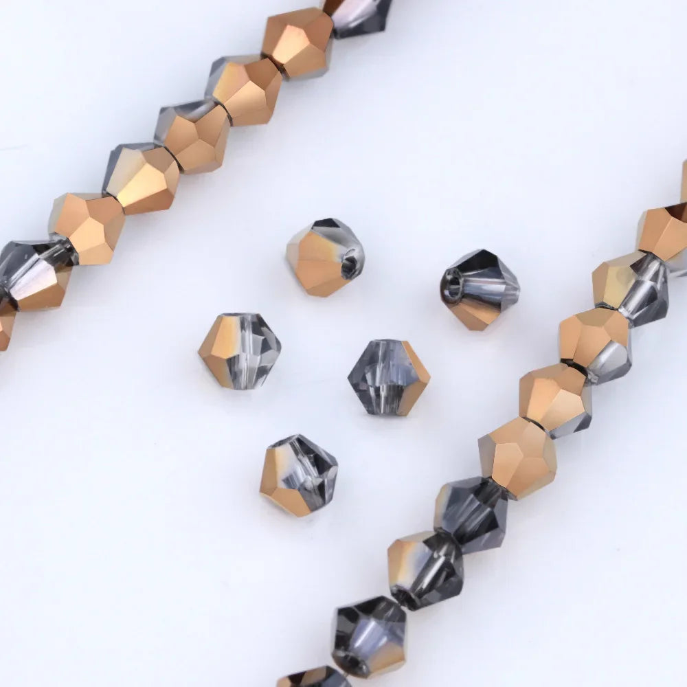A string of faceted glass beads in gold and gray tones for jewelry making